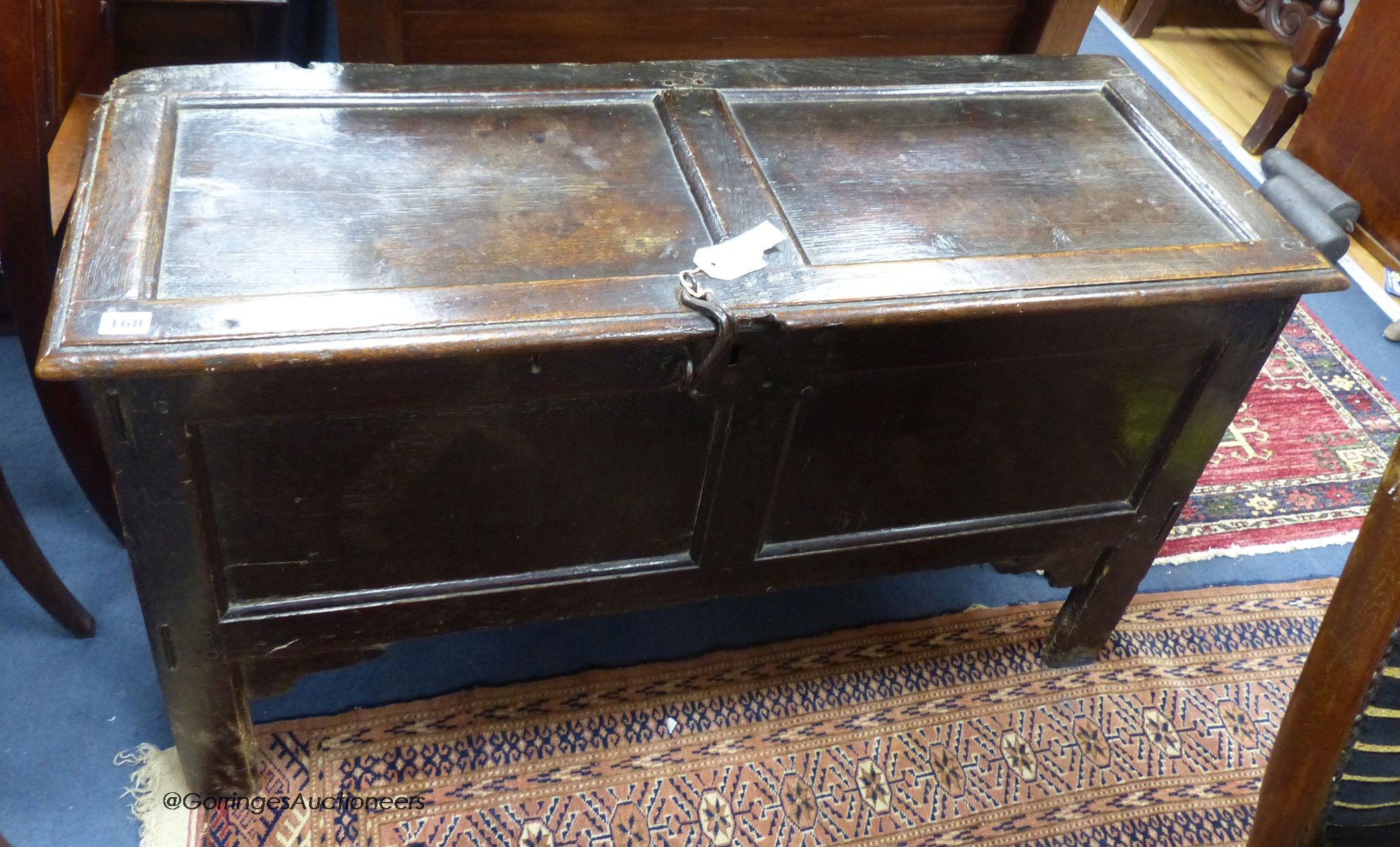 An early 18th century panelled oak plank coffer, length 106cm, depth 41cm, height 62cm